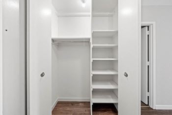 Walk-in closet with shelving and hanging rod